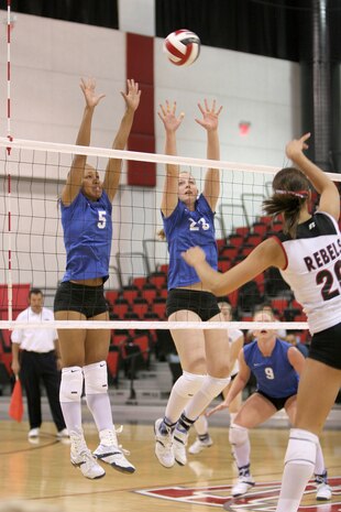 Air Force Academy Falcons Jasamine Pettie (left) and Nichole Stilwell go up to block a kill from University of Nevada Las Vegas' Sara Nehf during a match at the Cox Povilian in Las Vegas, Nev., Oct. 6.  The Falcons went on to drop the match by three sets. (U.S. Air Force Photo by Master Sgt. Robert W. Valenca)
