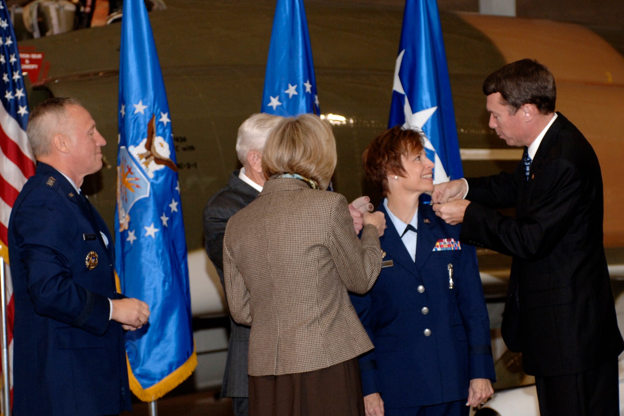 HILL AIR FORCE BASE, Utah-- Newly promoted Maj. Gen. Kathleen Close gets her second-star pinned on by her husband retired Col. Mike Close, her sister Patricia Balph, and her godfather retired Col. Patrick Kenny. (U.S. Air Force photo by Todd Cromar)