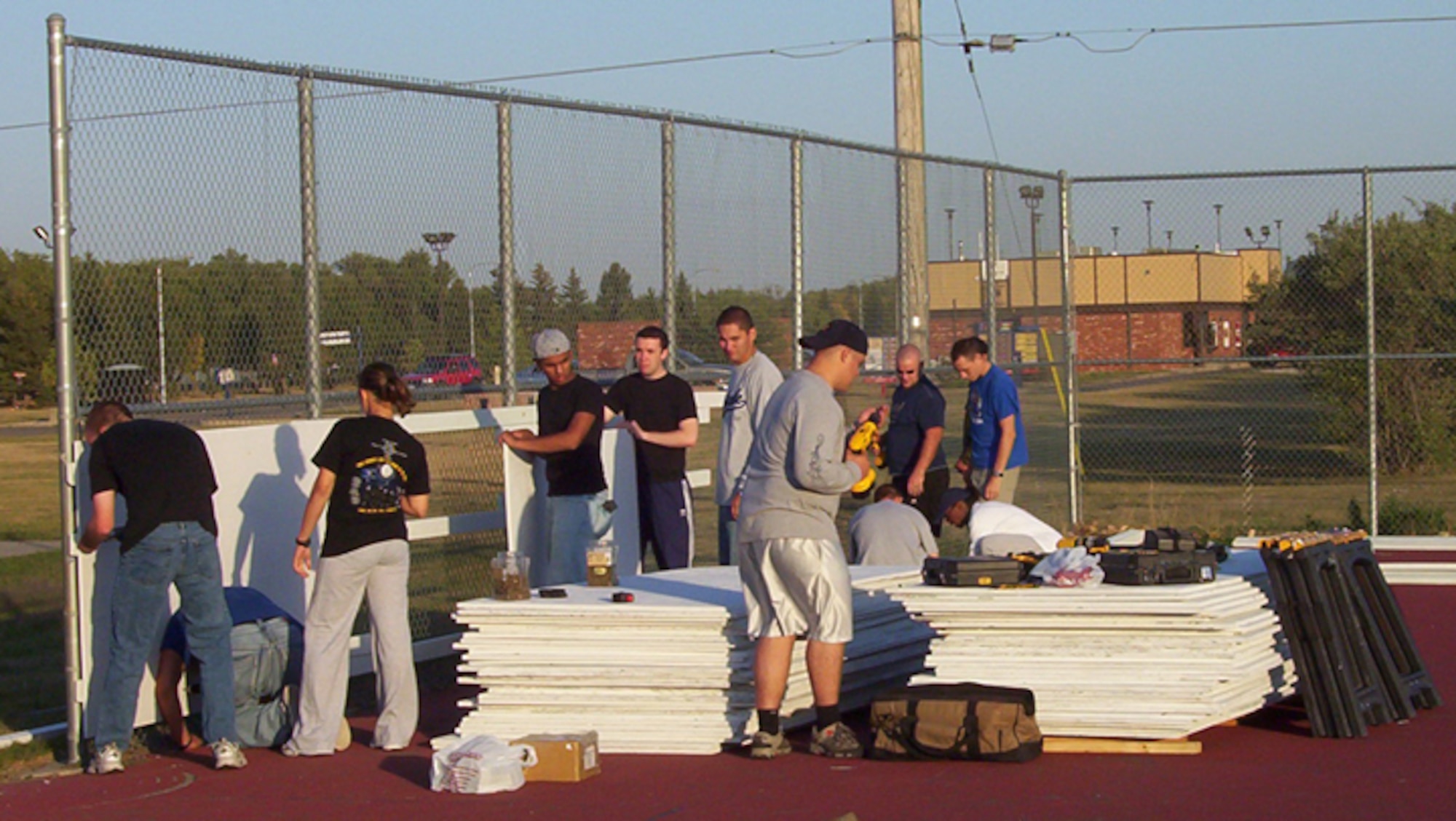 MINOT AIR FORCE BASE, N.D. -- Volunteers help construct the side-boards for the new ice/hockey rink here Oct 2. Airmen, spouses and dependants have contributed more than 450 hours in efforts to construct the new ice rink located between the base pool and the Professional Development Center here. (U.S. Air Force photo by Airman 1st Class Joe Rivera)