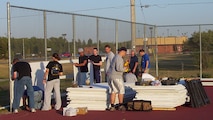 MINOT AIR FORCE BASE, N.D. -- Volunteers help construct the side-boards for the new ice/hockey rink here Oct 2. Airmen, spouses and dependants have contributed more than 450 hours in efforts to construct the new ice rink located between the base pool and the Professional Development Center here. (U.S. Air Force photo by Airman 1st Class Joe Rivera)