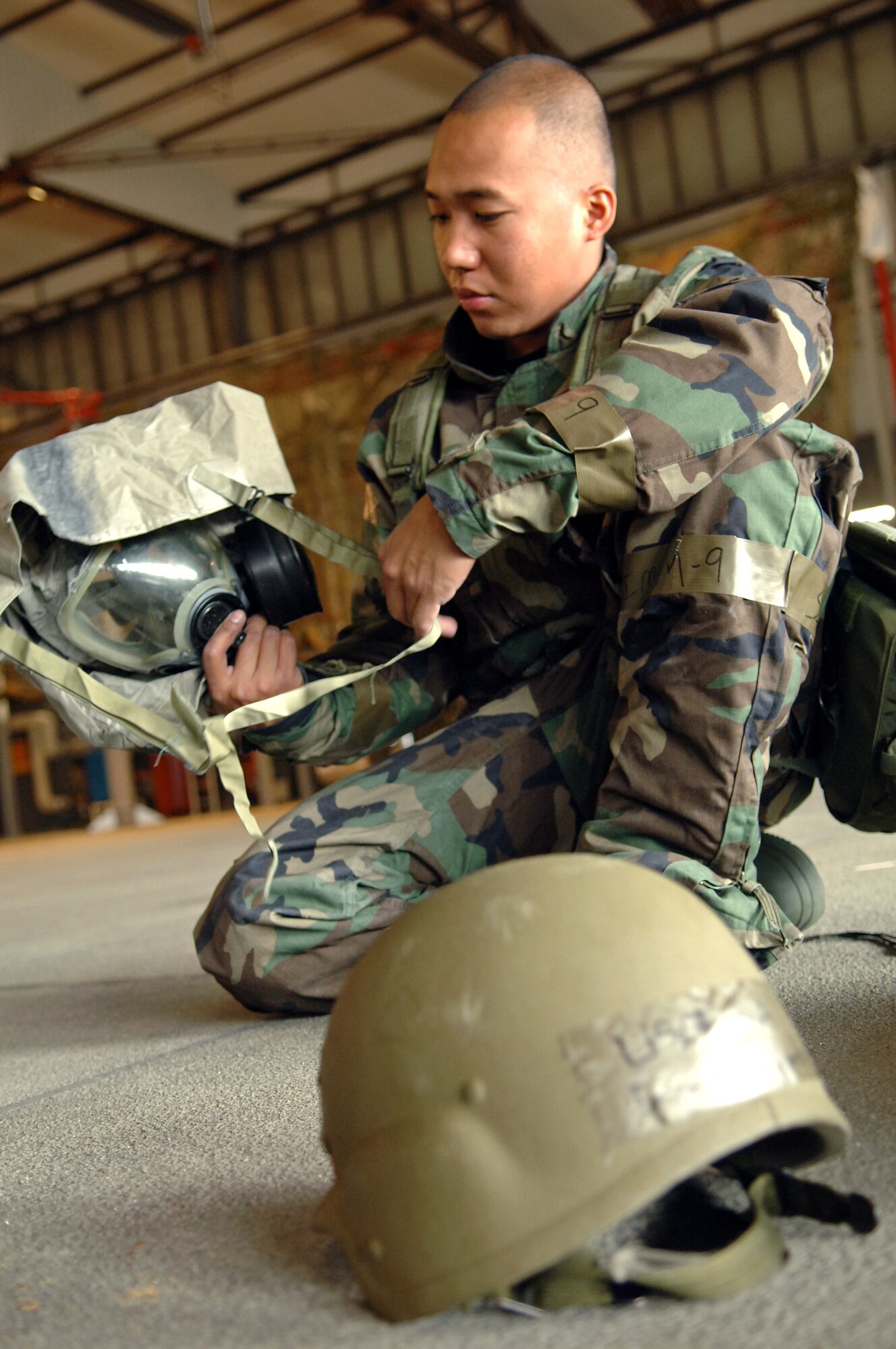 Senior Airman Francis Valiente, 735 Civil Engineer Squadron heating and ventilation technician, performs operation checks to his MCU-2A/P protective mask during Warrior Day on Ramstein Air Base, Germany, Oct. 4. Warrior Day provides pre-operational briefings to various units participating in the upcoming Operational Readiness Exercise. The exercise is designed to test the ability of Airmen to survive in austere environments with chemical, biological, radiological, nuclear, and explosive hazards. (U.S. Air Force photo/Airman 1st Class Marc I. Lane)