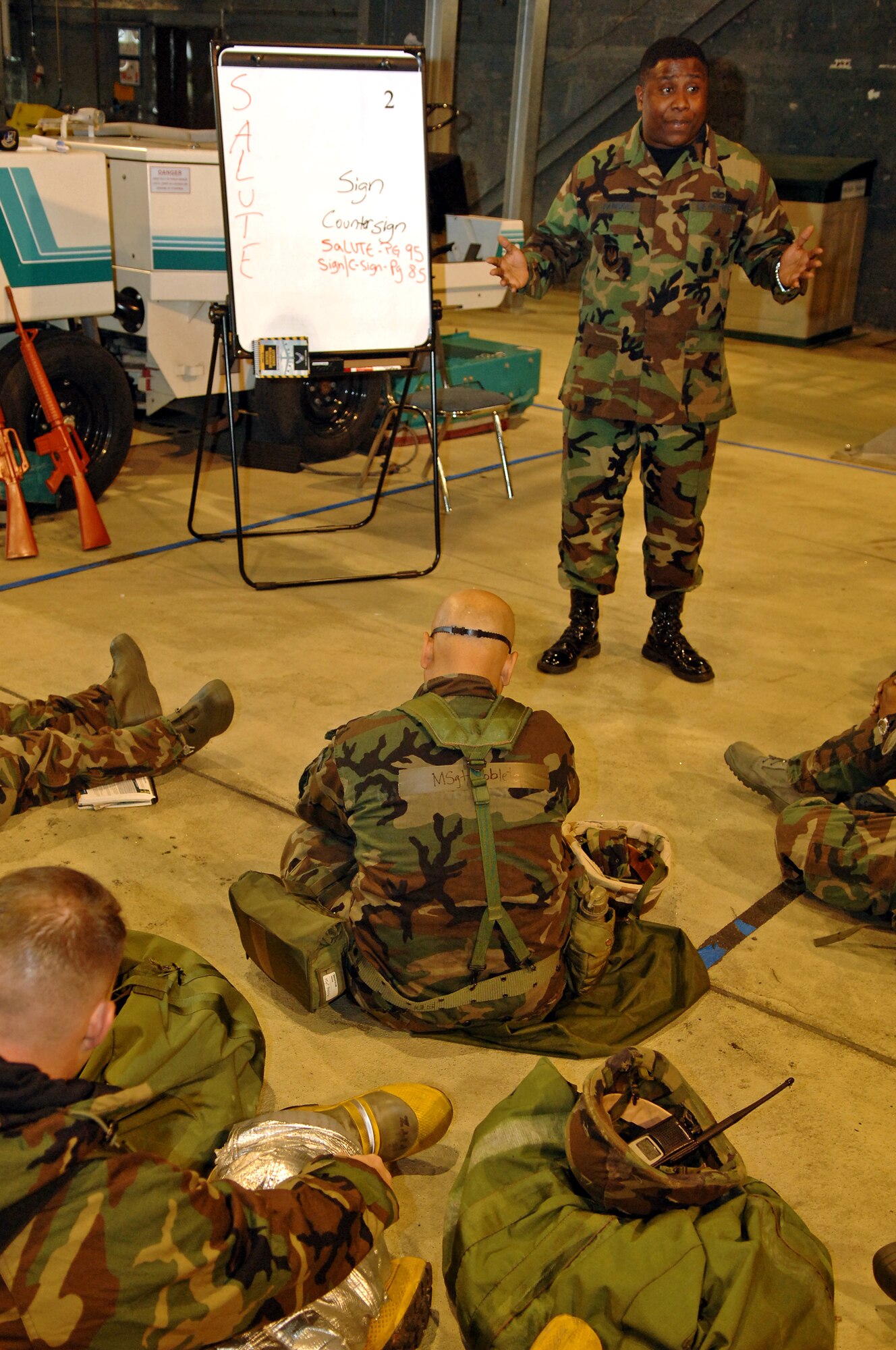 Staff Sgt. Willie Johnson, 435th Security Forces Squadron, explains reporting, sign and countersign, and challenging procedures during Warrior Day on Ramstein Air Base, Germany, Oct. 4. Warrior Day provides pre-operational briefings to various units participating in the upcoming Operational Readiness Exercise. The exercise is designed to test the ability of Airmen to survive in austere environments with chemical, biological, radiological, nuclear, and explosive hazards. (U.S. Air Force photo/Airman 1st Class Marc I. Lane)