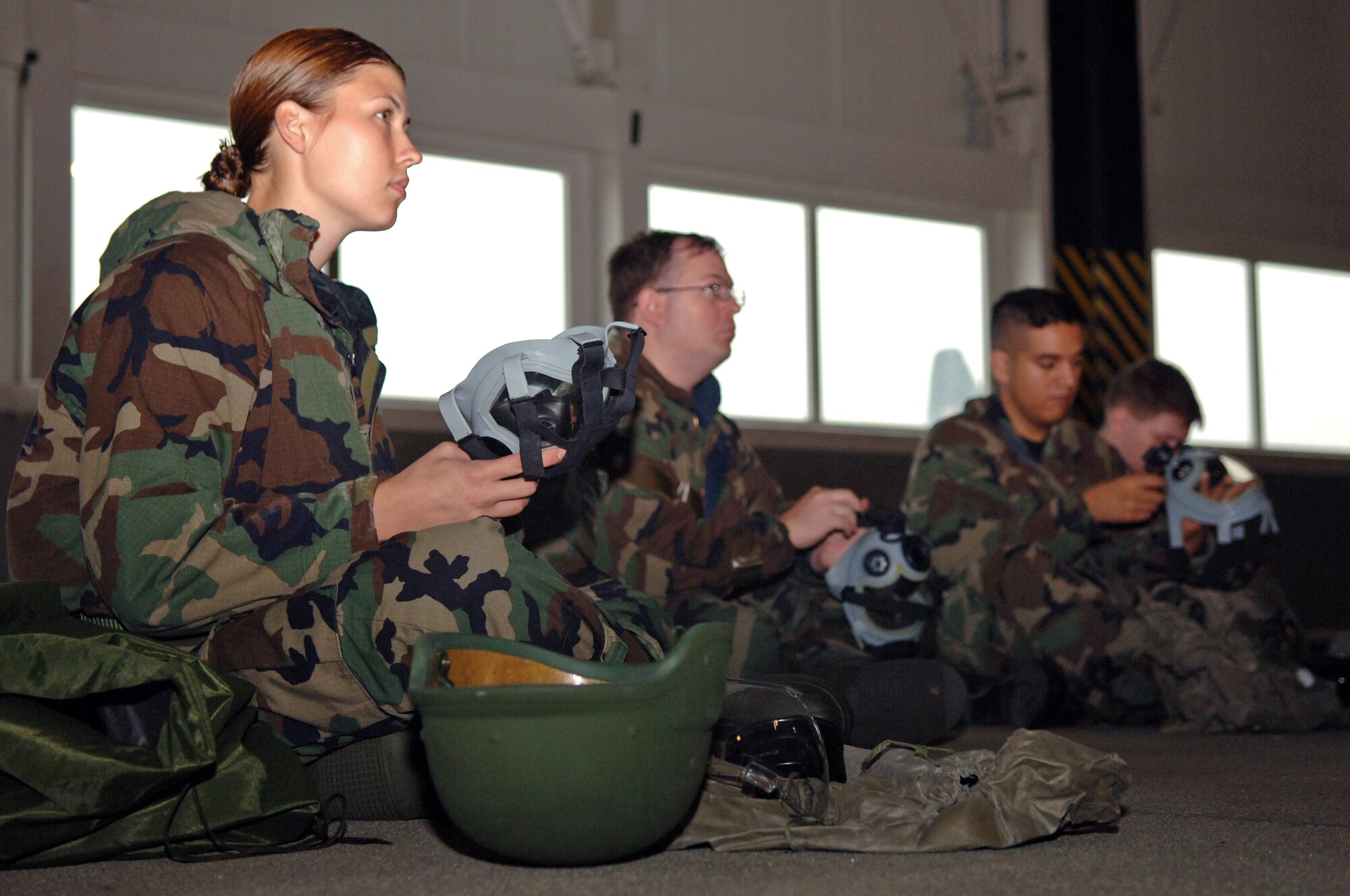(From left) 1st. Lt. Jennifer Kissel, 37th Airlift Squadron C-130 pilot, Staff Sgt. Keith Temple, 86th Operations Support Squadron aircrew flight equipment craftsman, and Airman 1st Class William Simpson, 86th Operations Group client supportive administrator, perform operation checks to their MCU-2A/P protective masks during Warrior Day on Ramstein Air Base, Germany, Oct. 4. Warrior Day provides pre-operational briefings to various units participating in the upcoming Operational Readiness Exercise. The exercise is designed to test the ability of Airmen to survive in austere environments with chemical, biological, radiological, nuclear, and explosive hazards. (U.S. Air Force photo/Airman 1st Class Marc I. Lane)