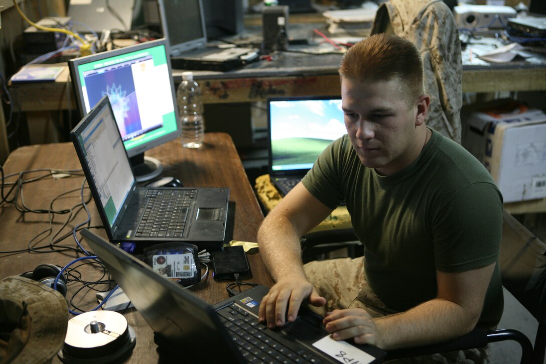 AL TAQADDUM, Iraq - Cpl. Christopher Wallace, a data technician for Marine Wing Support Squadron 272 creates a disc to install special drivers for use with the unit's network domain, Oct. 11.  Wallace works in the unit's communications shop which maintains the use of the unit's communications like phone and internet service.