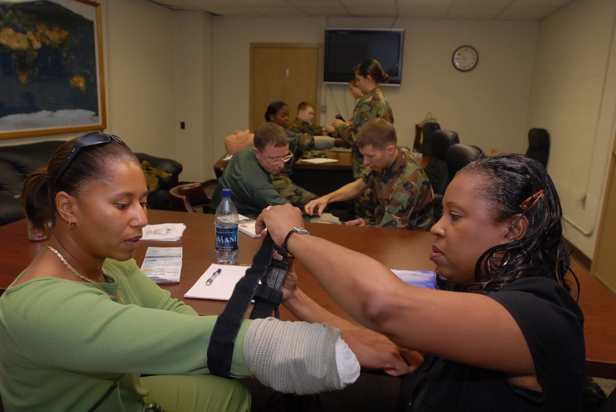 Students practice slinging broken arms during a self aid buddy care class at Kadena Air Base, Japan, Oct. 10, 2007. SABC allows Airmen to take care of each other when injured and awaiting medical care.  (U.S. Air Force /Senior Airman Darnell T. Cannady)
