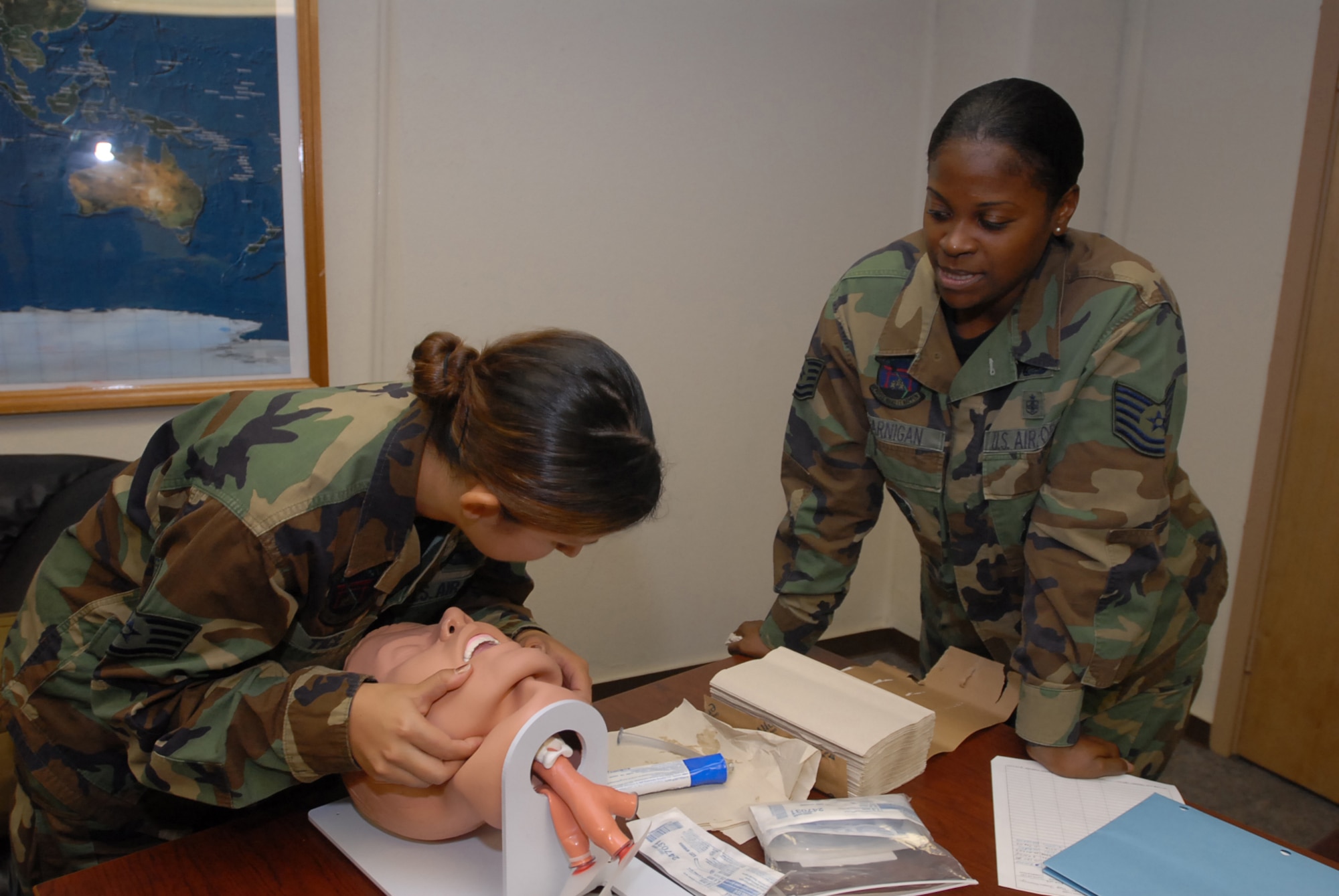 Staff Sgt. Jennifer Tice checks for breathing while the instructor Tech. Sgt. Issomi Garnigan observes during a self aid buddy care class at Kadena Air Base, Japan, Oct. 10, 2007. SABC allows Airmen to take care of each other when injured and awaiting medical care. Both sergeants are assigned to the 18th Mission Support Squadron. (U.S. Air Force /Senior Airman Darnell T. Cannady) 