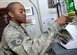 BALAD AIR BASE, Iraq -- Staff Sgt. Justin Gholston, 332nd Air Expeditionary Wing cashier, uses an automatic money counter to count the money used to cash checks from servicemembers here. This vital service gives Airmen the ability to access the right amount of funds to meet their needs. Sergeant Gholston is deployed from the 1st Comptroller Squadron at Langley. (U.S. Air Force Photo/Senior Airman Travis Edwards)
