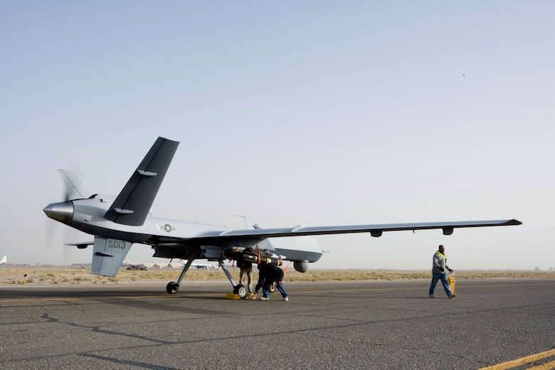 Aircrews perform a preflight check on an MQ-9 Reaper before it takes off on a mission in Afghanistan Oct. 1. The Reaper is larger and more heavily-armed than the MQ-1 Predator and attacks time-sensitive targets with persistence and precision, to destroy or disable those targets. (Courtesy photo)