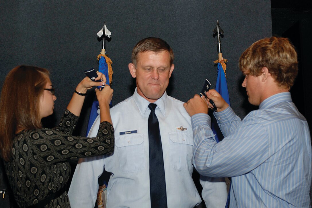 Major Gen. Frank Gorenc, commander of the Air Force District of Washington, receives two star epaulets from his daughter, Helen, and son Michael, during a promotion ceremony at Langley AFB, Va., on Oct. 1. AFDW provides the single Air Force voice and component to the Joint Forces Headquarters-National Capital Region, as well as organizes, trains and equips combat forces for the aerospace expeditionary forces, homeland operations, civil support, national special security events and ceremonial events. In addition, AFDW serves as Uniform Code of Military Justice authority for more than 40,000 personnel and provides major command-level support for more than 24,000 personnel assigned worldwide.