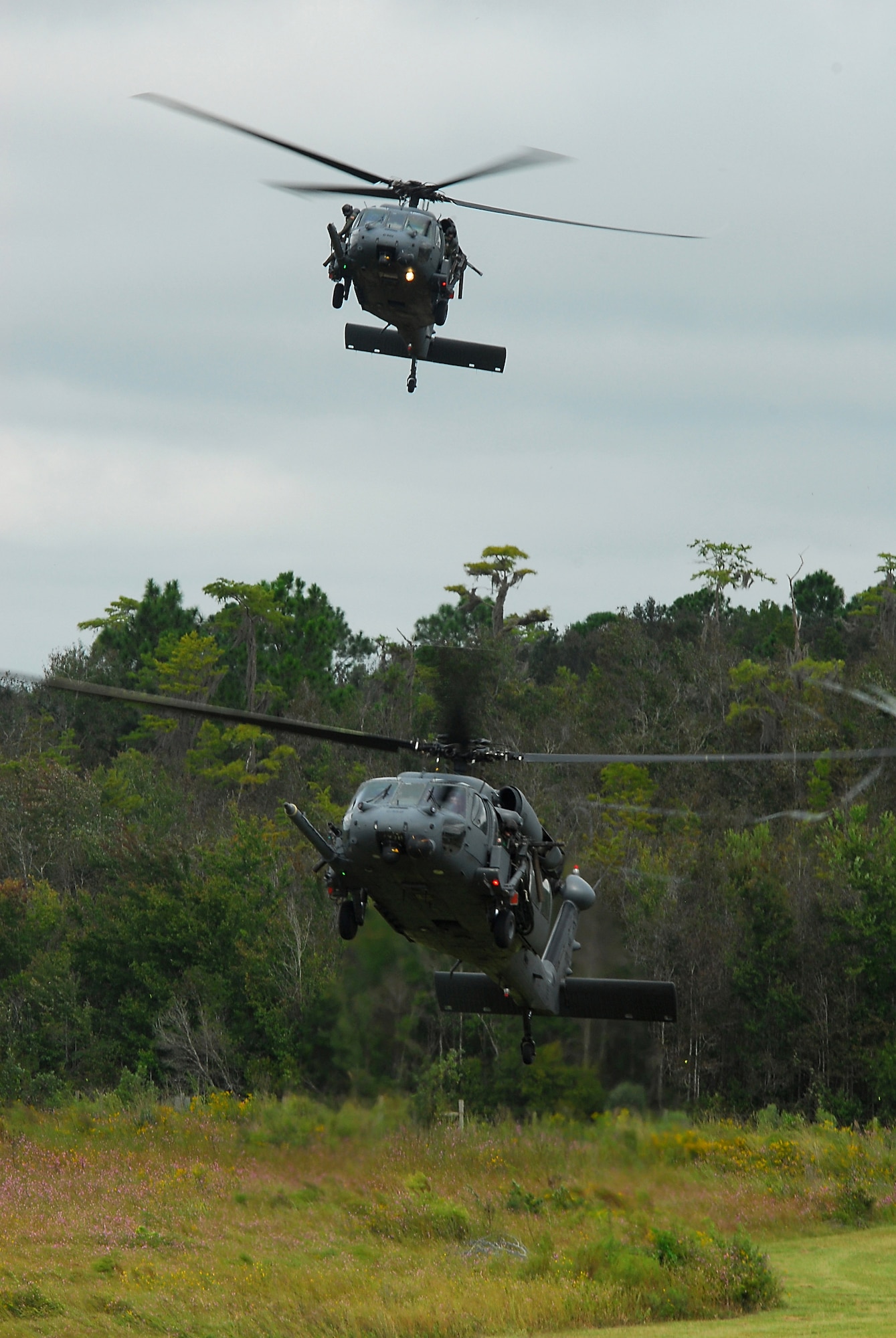 Two HH-60G Pave Hawks from the 41st Rescue Squadron approach a landing zone during a combat search and rescue demonstration at Moody Air Force Base, Ga., Oct. 4. The primary role of the HH-60G is to conduct day or night CSAR operations into hostile environments to recover downed aircrew or other isolated personnel during war. (U.S. Air Force photo/Tech. Sgt. Parker Gyokeres)