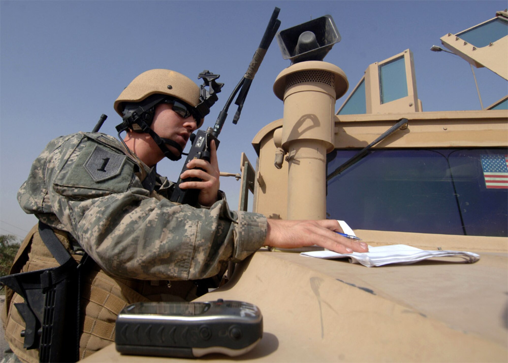 Senior Airman Zach Laird radios the aircrew of an Air Force B1-B Lancer to get an update on bombs being dropped on a building in Baghdad, Iraq, to neutralize an insurgent detonation point for improvised explosive devices.  Airman Laird is assigned to the 3rd Air Support Operations Group.  (U.S. Navy photo/Petty Officer David Quillen)