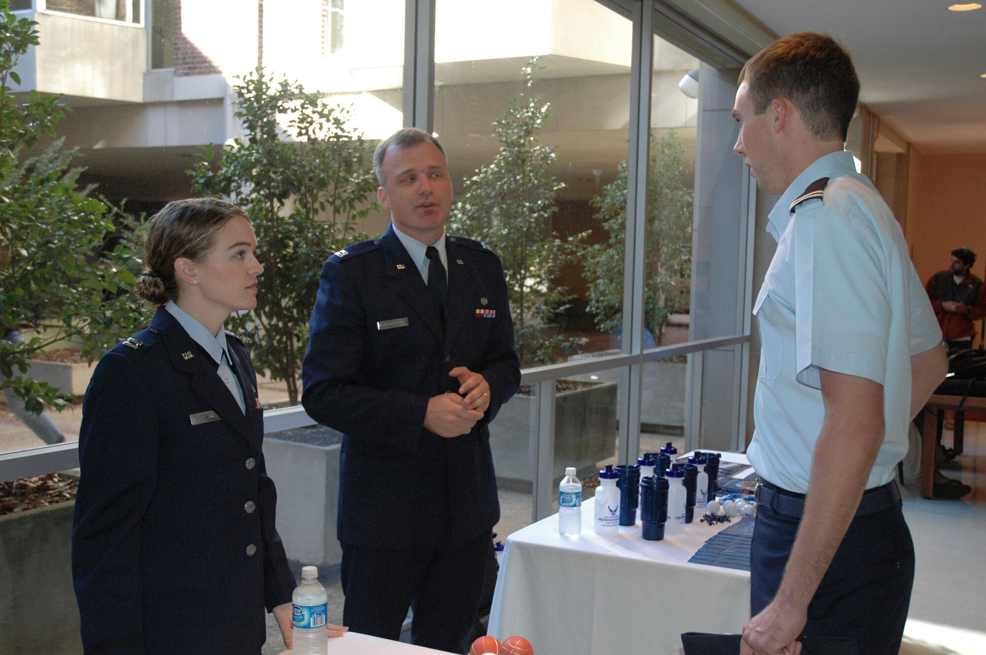 Assistant Staff Judge Advocate Capt. Jennifer Powell (left) and Area Defense Counsel Attorney Capt. Wes McConnell (center), both from Robins Air Force Base, Ga., talk about opportunities to serve in the Air Force?s Judge Advocate General?s Corps to Cadet Brock Marsh (right) from Detachment 160 of the University of Georgia?s Air Force Reserve Officer Training Corps.  The captains were at the University of Georgia during a visit from Maj. Gen. Jack L. Rives, the Judge Advocate General of the Air Force.  General Rives, a UGA alumni, came to the area as part of Air Force Week Atlanta.