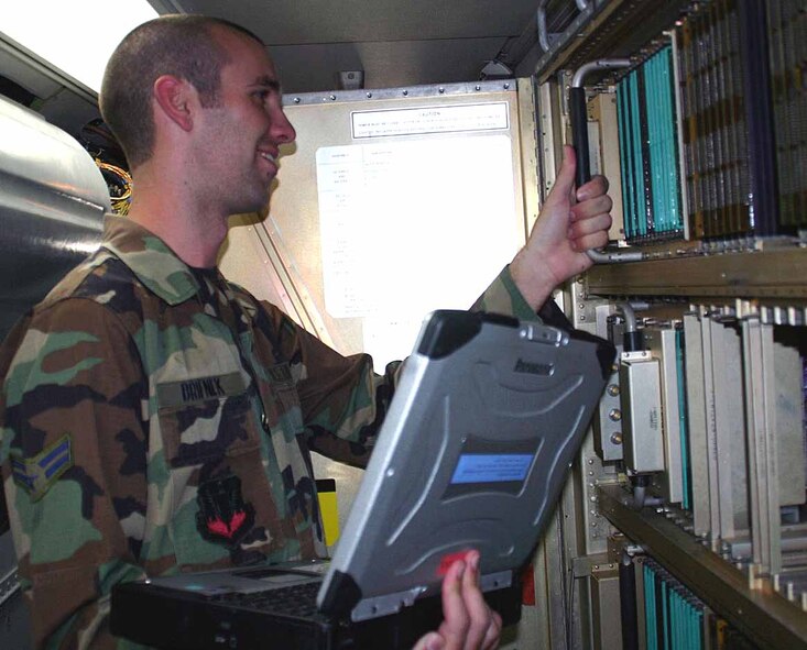 Airman 1st Class Michael Brifnek, 552nd Maintenance Squadron Computer Flight, inspects the hardware used during an E-3 mission. (Air Force photo by Staff Sgt. Stacy Fowler)