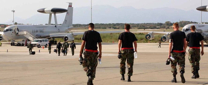 Airmen in the 552nd Maintenance Squadron head out to the jet at the beginning of the day during a deployment to Crete for a president of the United States support mission. (Air Force photo by Staff Sgt. Stacy Fowler)