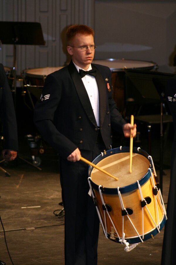 SrA David Pojar of the USAF Heartland of America Band's Brass in Blue joins the group at the front of the stage with his rope drum as part of the group's tribute to veterans in the audience.  The group was honored to perform for veterans across northern Minnesota in October 2007.