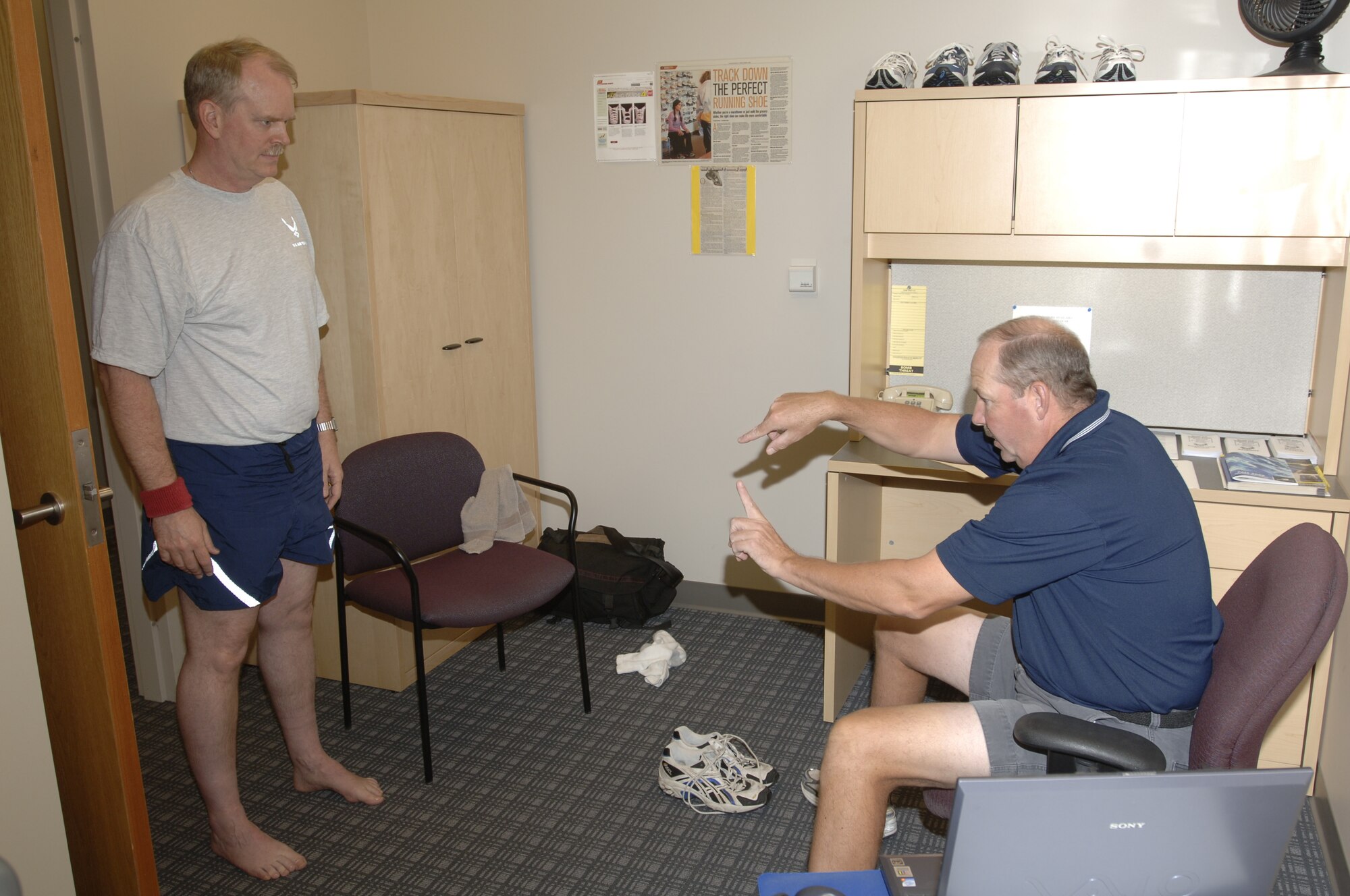 MCCONNELL AIR FORCE BASE, Kan. -- Bart Patterson, Health and Wellness Center health technician, is checking Lt. Col. Jon Woods’, 931st Operation Support Flight, arches during a running shoe evaluation Oct. 1, at the HAWC.  Most running injuries can be traced back to the condition or type of running shoe that person uses. (Photo by Airman 1st Class Roy Lynch III.)