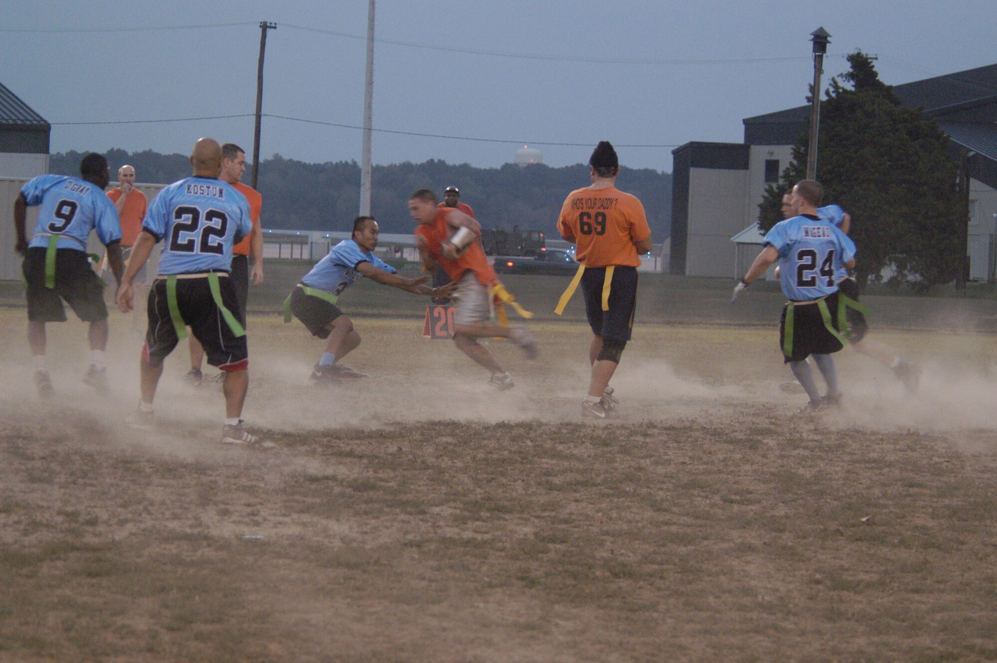 Robert Duran, MXS, tries to block Nicholas Kolesnikov, CPTS/OG, as he sprints for territory Tuesday night during the intramural flag football game resulting in 6 – 0 win for the CPTS/OG team. (U.S. Air Force photo/Airman Shen-Chia Chu)                                                     