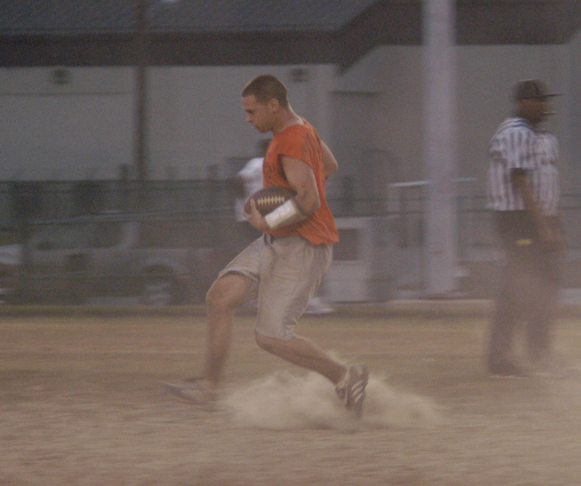 Nicholas Kolesnikov, 436th Comptroller Squadron/512th Operations Group, bolts down the field keeping a tight grip on the leather. (U.S. Air Force photo/Airman Shen-Chia Chu)                                                          