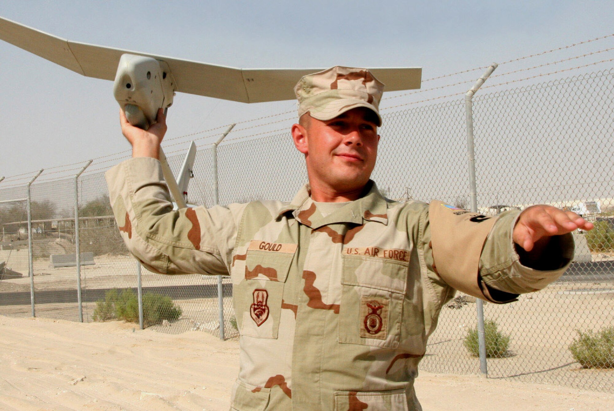 Airman 1st Class James Gould demonstrates how the Raven B is hand-launched for missions. Airman Gould is a certified Raven B operator from the 380th Expeditionary Security Forces Squadron in Southwest Asia. (U.S. Air Force photo/Master Sgt. Ruby Zarzyczny)