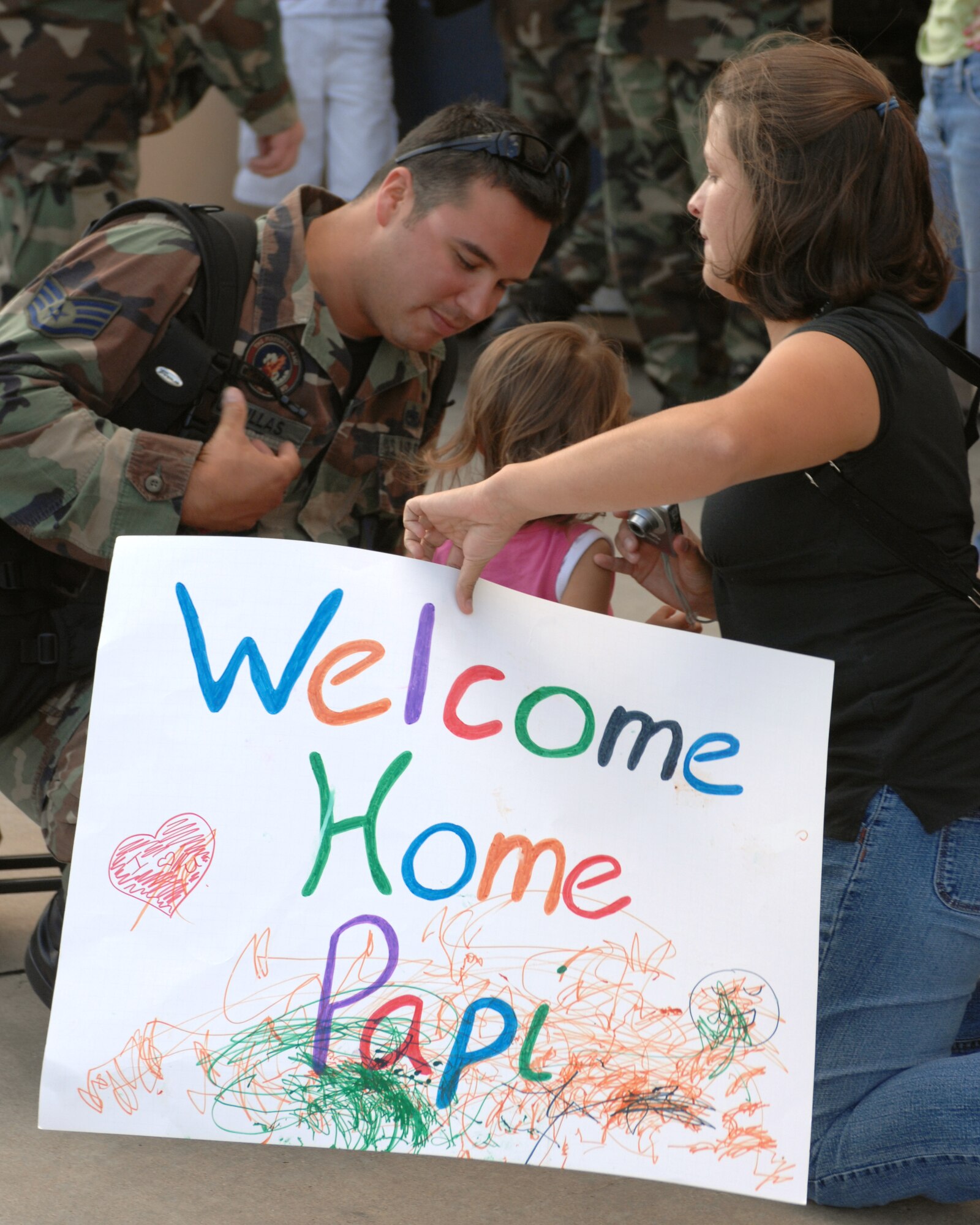 CANNON AIR FORCE BASE, N.M. - Staff Sgt. Gilbert Casillas, 522nd Aircraft Maintenance Unit, is greeted by his wife and daughter after returning from his deployment to Guam. The Airmen left a Fighter Wing base and returned to a Special Operations Wing base. (U.S. Air Force photo by Airman 1st Class Evelyn Chavez)