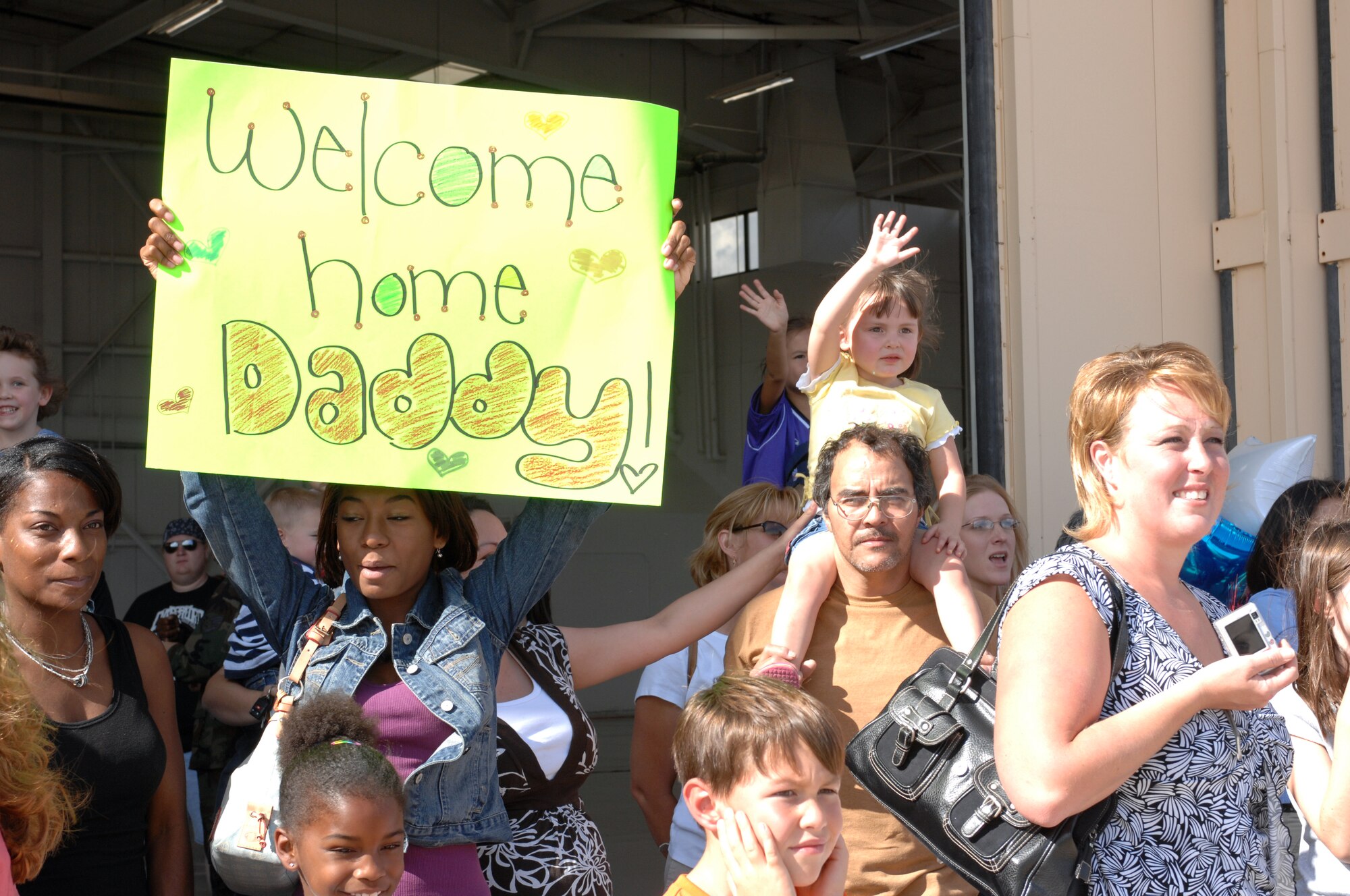 CANNON AIR FORCE BASE, N.M. - Family and friends await the return of Airmen from the 522nd Aircraft Maintenance Unit returning from Guam. The Airmen left a Fighter Wing base and returned to a Special Operations Wing base. (U.S. Air Force photo by Airman 1st Class Evelyn Chavez)