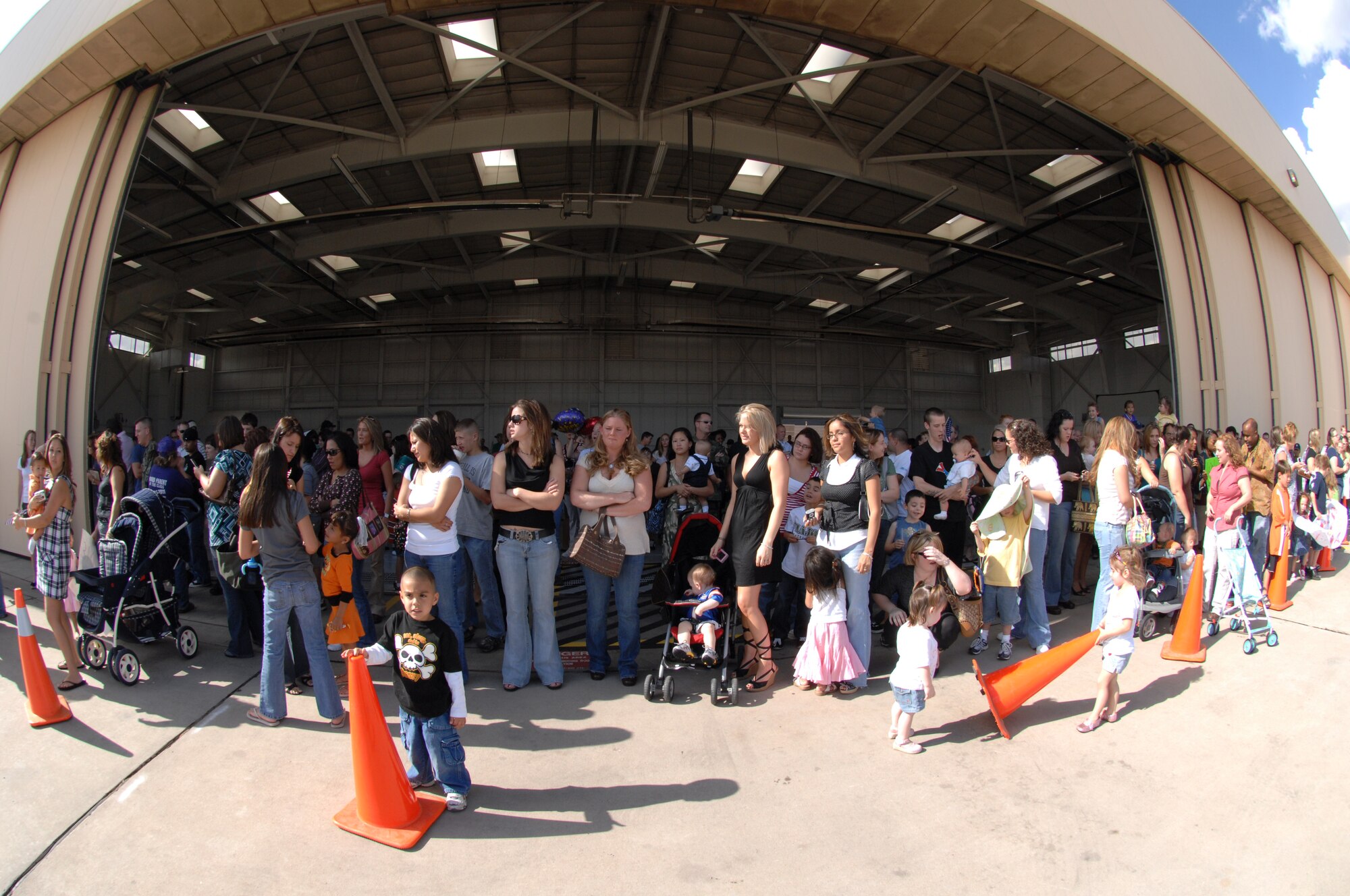 CANNON AIR FORCE BASE, N.M. - Family members and friends await the return of Airmen from the 522nd Aircraft Maintenance Unit who were deployed to Guam. The Airmen left a Fighter Wing base and returned to a Special Operations Wing base. (U.S. Air Force photo by Airman 1st Class Evelyn Chavez)