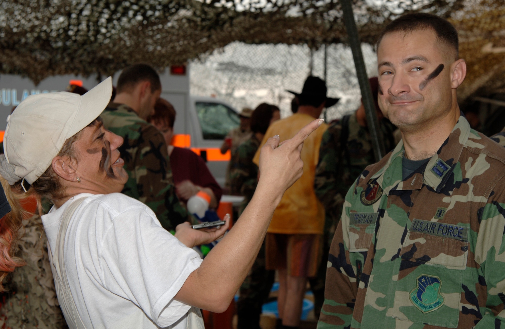 MCCONNELL AIR FORCE BASE, Kan. – Amy Radenmacher and Capt. Daniel Fridman, 22nd Aero Medical Dental Squadron, apply war paint to their faces at the 22nd Medical Group Dining In, Oct. 6. The 22nd Medical Dining-In event celebrated the MDG camaraderie throughout the evening.  (photo by Airman 1st Class Laura Suttles) 