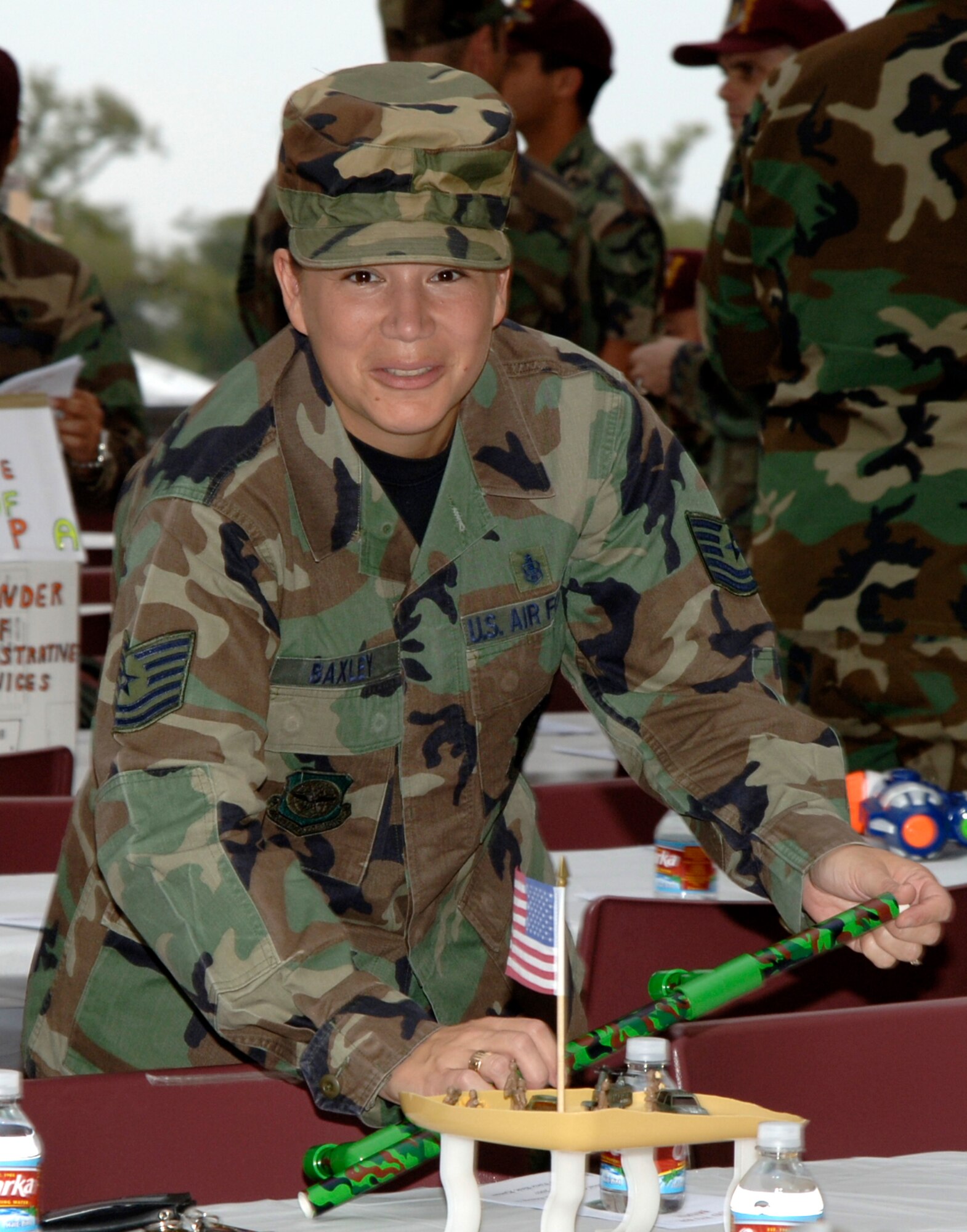 MCCONNELL AIR FORCE BASE, Kan. – Tech. Sgt. Tarah Baxley, 22nd Medical Support Squadron, helps decorate the tables at the 22nd Medical Group Dining-In Oct. 6. The activities for the night included Airmen racing to the Grog bowl, a dining-in tradition of entertaining and friendly punishment. Guest speaker Chief Master Sgt. Mark Withers, Air Force Medical Services chief, Office of the Surgeon General addressed Airmen throughout the evening.  (photo by Airman 1st Class Laura Suttles)