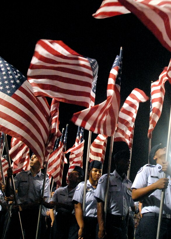 Flags flap in the wind and Air Force Junior ROTC members stand fast, ready to take their spots during the half time performance of the football game Oct. 6 between Midwestern State University in Wichita Falls and West Texas A&M from Canyon, Texas. Thousands of Airmen, Soldiers, Sailors and possibly future Airmen were honored during MSU's Salute to the Military. (U.S. Air Force photo/Mike Litteken)