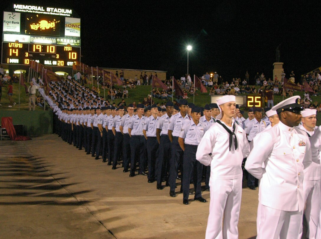 Hundreds of Team Sheppard Airmen and Sailors lineup to take the field during the half time performance at the Oct. 6 Midwestern State University Salute to the Military at Memorial Stadium in Wichita Falls, Texas. (U.S. Air Force photo/Harry Tonemah)