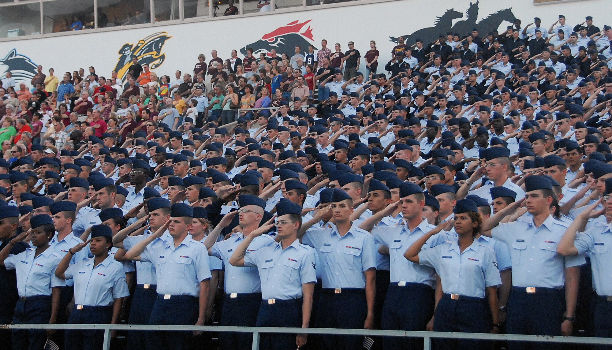Airmen from Sheppard Air Force Base, Texas, and fans honor the national anthem appropriately before the Midwestern State University vs. West Texas A&M game Oct. 6. MSU set aside this game as the time they would host military members from Sheppard and Fort Sill, Okla., during their annual Salute to the Military. (U.S. Air Force photo/Mike Litteken)