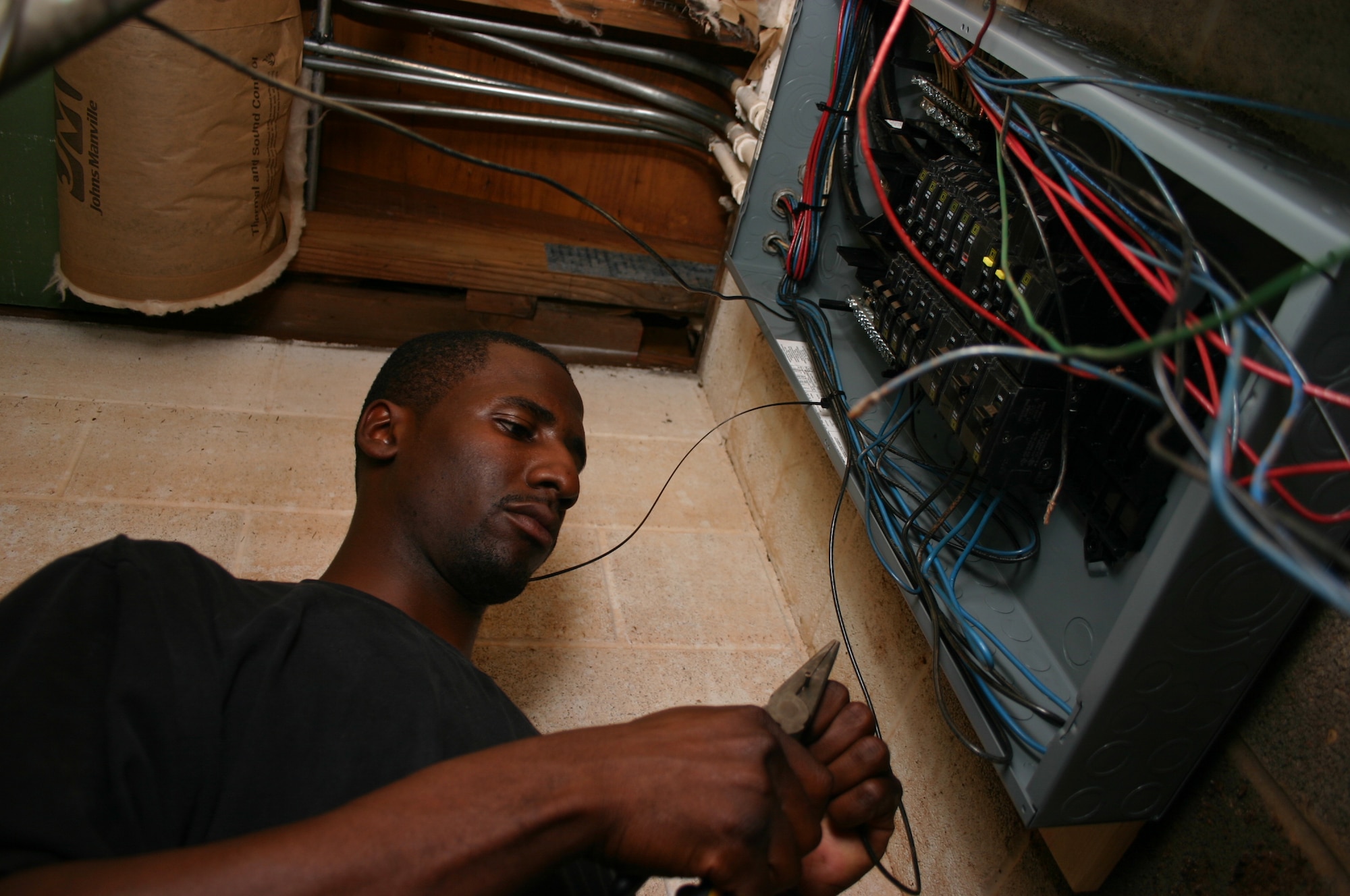 Senior Airman Marcus Brooks, an electrical systems journeyman with the 82nd Civil Engineer Squadron, rewires a breaker box for the restroom Oct. 4 at the Sheppard Annex at Lake Texoma. A team of CES and 82nd Services Division personnel worked to get the vacation getaway back in shape for use by Sheppard members. (U.S. Air Force photo/Staff Sgt. Tonnette Thompson)