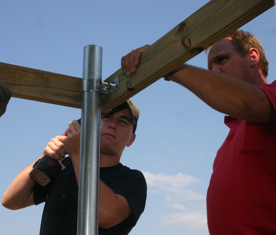 Airman James Frye, left, a utilities apprentice with the 82nd Civil Engineer Squadron, and James Trout, a CES work leader and carpenter, put up the framework of a new fence Oct. 4 at the Sheppard Annex at Lake Texoma. A team of CES and 82nd Services Division personnel worked to get the vacation getaway back in shape for use by Sheppard members. (U.S. Air Force photo/Staff Sgt. Tonnette Thompson)