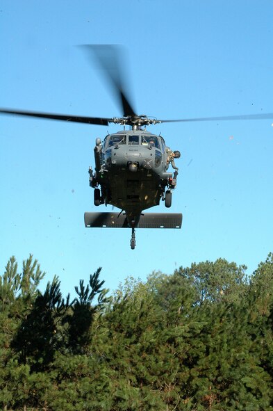 An HH-60 Pavehawk helicopter from the 301st Rescue Squadron at Patrick AFB, Fla., negotiates the treetops at Etowah High School in Woodstock, Ga. The chopper carried pararescuemen who visited the school and performed a display of tactics as part of Air Force Week Atlanta. Students at the school were also treated to several static displays from the 94th Airlift Wing at Dobbins Air Reserve Base, Ga., and a performance of the Air Force Honor Guard drill team with their skill-heavy drill that had jaws on the floor. (U.S. Air Force photo/Micah Garbarino) 