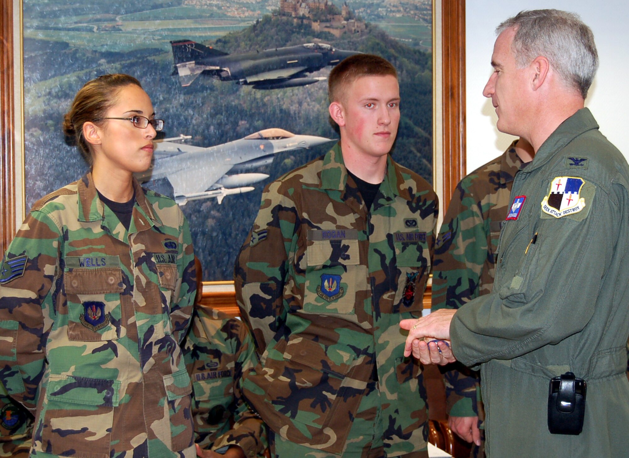 SPANGDAHLEM AIR BASE, Germany – Col. Thomas Feldhausen, 52nd Fighter Wing vice commander, thanks Airman 1st Class David Rogan, 52nd Civil Engineer Squadron, and Staff Sgt. Ashley Wells, 52nd Services Squadron, for their hard work which earned them an outstanding score on their career development course exam Oct. 10. (U.S. Air Force photo/Staff Sgt. Tammie Moore)
