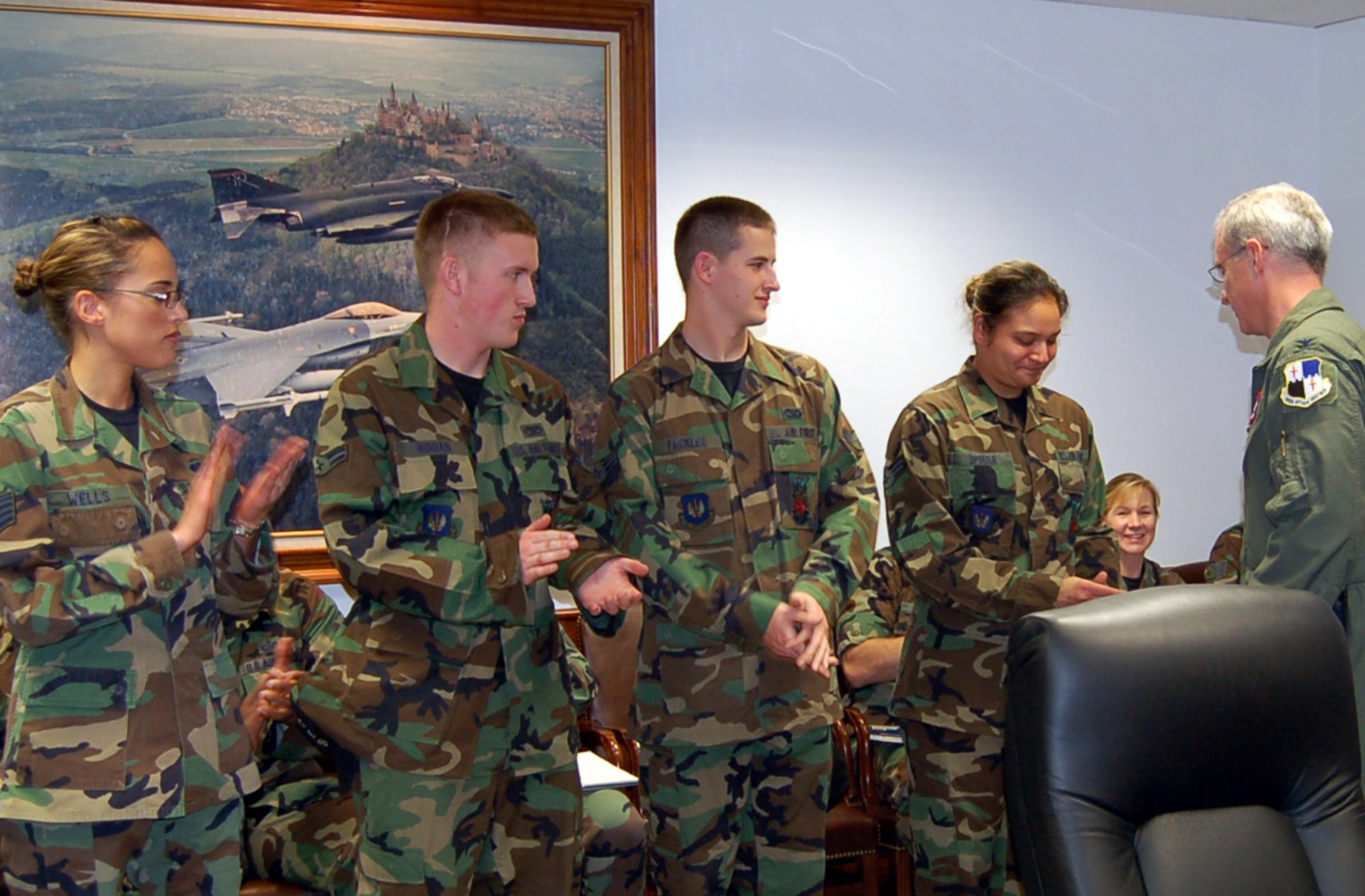 SPANGDAHLEM AIR BASE, Germany – Col. Thomas Feldhausen, 52nd Fighter Wing vice commander, presents Senior Airman Cheyenne Opiana, 52nd Civil Engineer Squadron, with a coin for her outstanding score on her career development course exam Oct. 10. (U.S. Air Force photo/Staff Sgt. Tammie Moore)