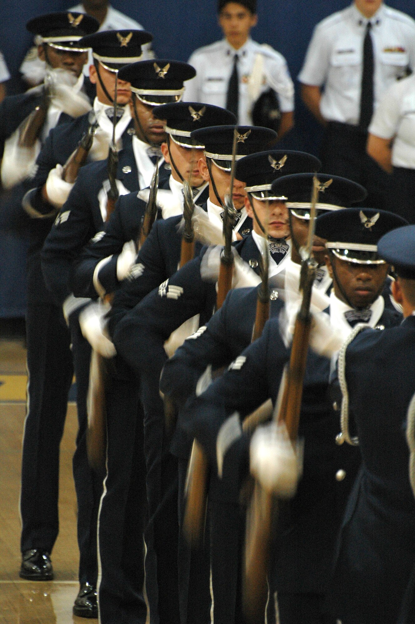Members of the Air Force Honor Guard Drill Team perform a "domino" maneuver during a fantastic drill routine at Etowah High School in Woodstock, Ga. Oct 10. The team was part of a large group of Air Force members, active and reserve, who descended on the school to share their story during Air Force Week Atlanta. Students at Etowah were not only treated to a drill performance, but also to a helicopter landing and a demonstration of tactics from members of the 301st Rescue Squadron, Patrick AFB, Fla. and several static displays from the 94th Airlift Wing at Dobbins Air Reserve Base, Ga. (U.S. Air Force photo/Micah Garbarino)