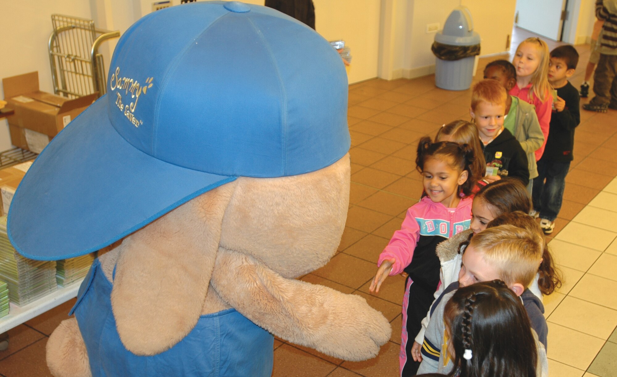 AVIANO AIR BASE, Italy--Children from Aviano 
Elementary School  shake hands with Sammy the Rabbit Oct. 9. Sammy is part of the ?It?s a Habit? Company Inc., a program designed to teach children the importance of saving money and making it a habit. (U.S. Air Force Photo by Senior Airman Justin Weaver).