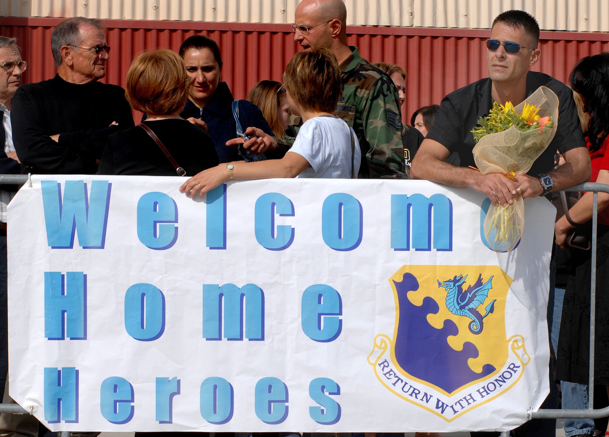 Aviano Air Base, Italy-- Staff Sgt. Larry Clunk, 555th Fighter Squadron,  waits patiently for his wife, Senior Airman Amy Clunk, to debark a plane Oct. 9.  here.  More than 230 Airmen returned from a four-month deployment to Kunsan Air Base, South Korea. ( U.S. Air Force photo/Airman First Class Nathan Doza )