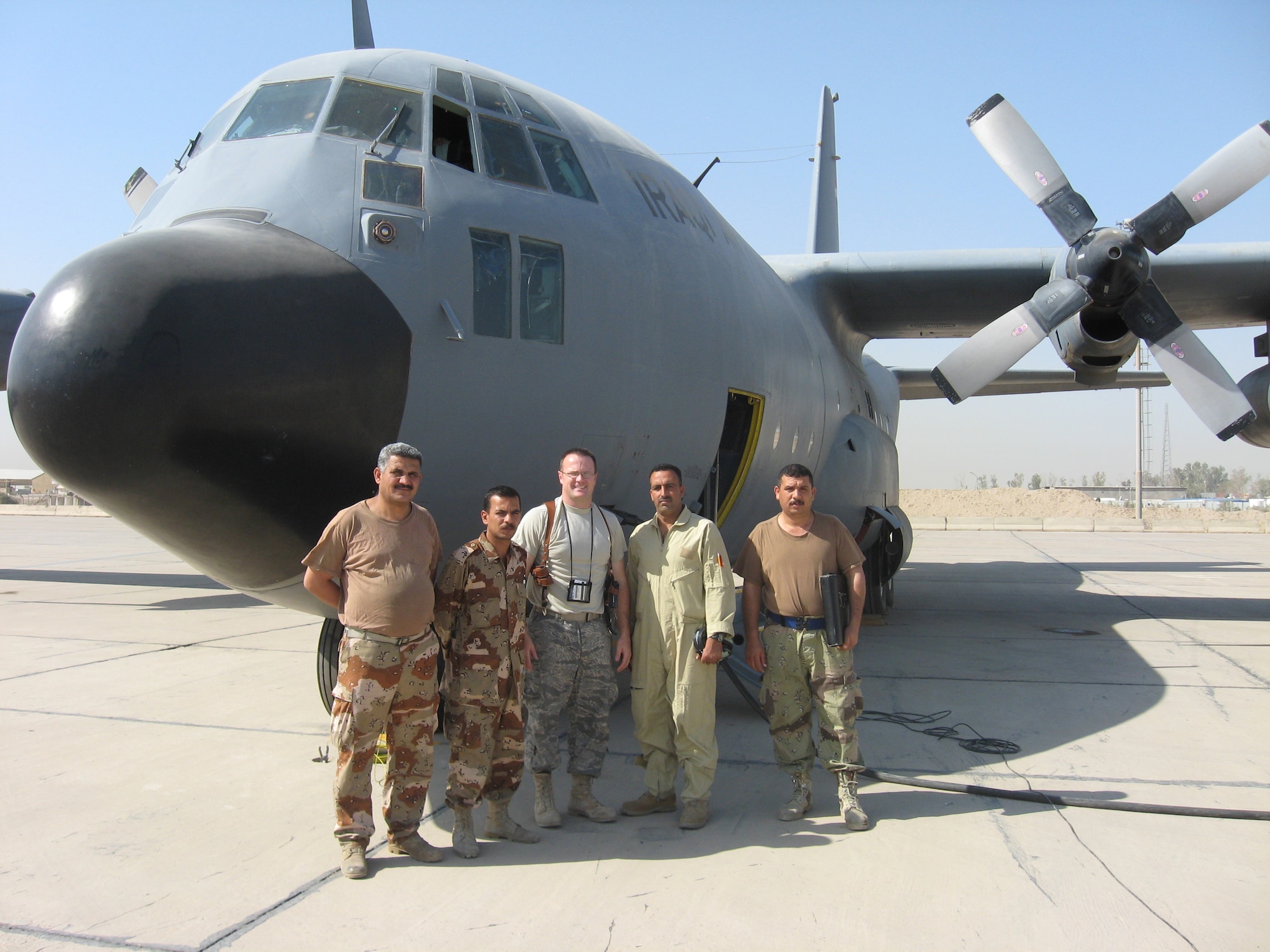 Tech. Sgt. Steven Miller (center) stands with some of the Iraqi C-130 Electrical and Environmental technicians in Iraq. Sergeant Miller is on a one-year deployment training the Iraqi aircraft mechanics on C-130 maintenance. (Courtesy photo)