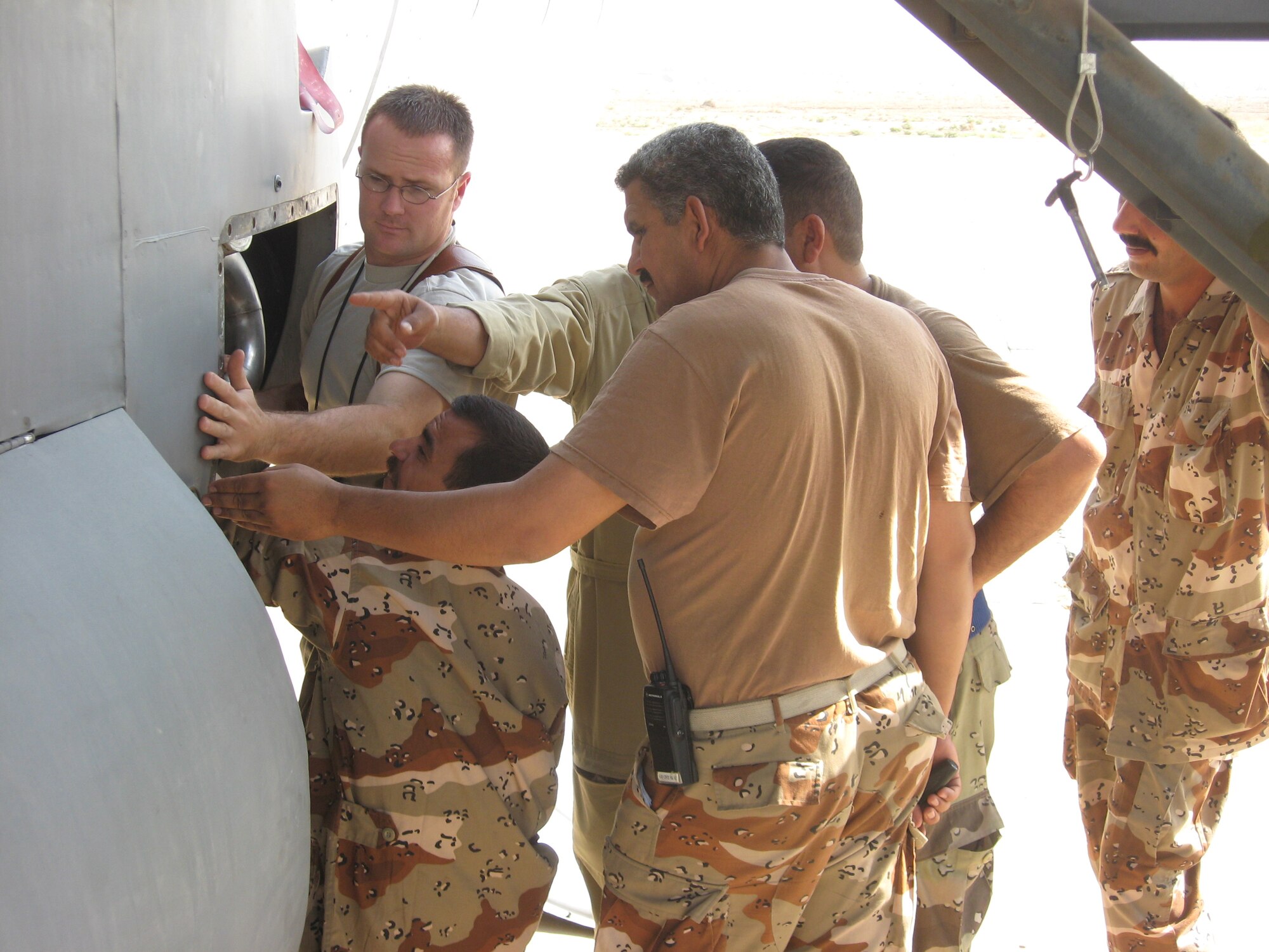 Sergeant Miller gives hands-on instructions to Iraqi aircraft mechanics on servicing C-130 electrical and environmental systems. For the new Iraqi airmen, working on C-130 airframes is very different than the Russian An-24 craft they are accustomed to maintaining. (Courtesy photo)