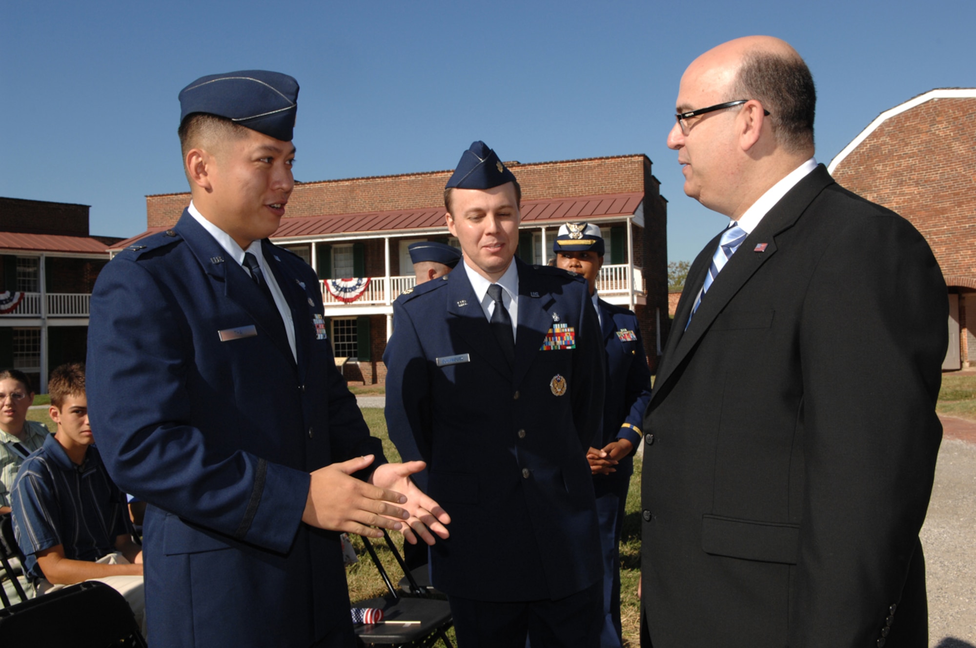 Capt. Van Thai (left), current operations flight commander for the 18th Operations Support Squadron, talks with Dr. Emilio Gonzalez (right), U.S. Citizenship and Immigration Services director, prior to the Outstanding American by Choice award ceremony Sept. 24 at Ft. McHenry National Monument and Historic Shrine, Md.
(Courtesy photo)