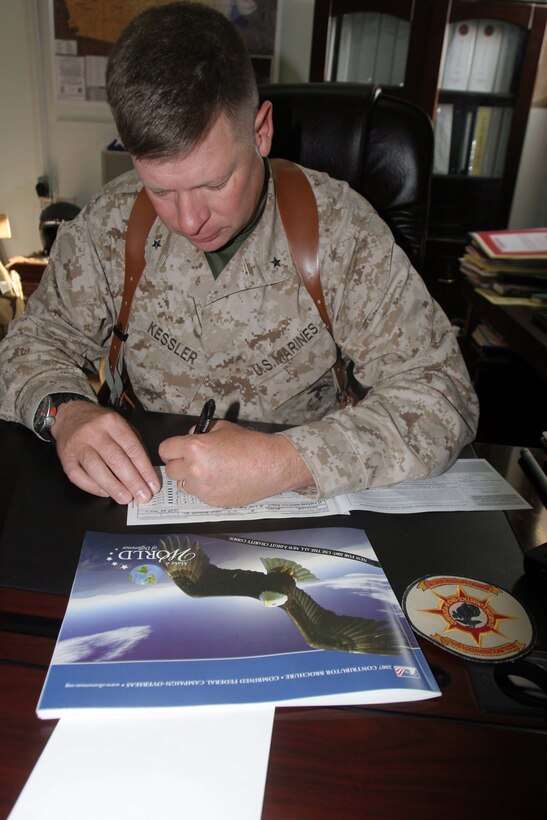 Brig. Gen. James A. Kessler kicks off the annual Combined Federal Campaign contributions for 2nd Marine Logistics Group (Forward). The CFC helped raise more than $271 million in charitable donations during its 2006 drive for thousands of non-profit organizations. Kessler is the commanding general for 2nd MLG (Fwd).