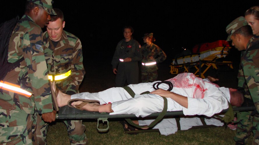 71st Medical Group personnel transport a simulated civilian casualty with injuries to an immediate care facility during a Medical Unit Readiness Training exercise Oct. 11. The annual training ensures medical personnel are prepared to perform their duties in a deployed environment. (U.S. Air Force photo by Tech. Sgt. Mary Davis)                                                                                   