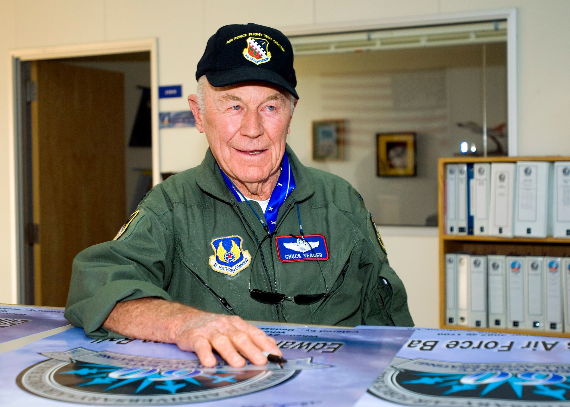 Retired Brig. Gen. Chuck Yeager pauses for a moment while autographing several posters at Edwards Air Force Base, Calif. General Yeager became the first man to fly faster than the speed of sound in level flight on October 14, 1947. (U.S. Air Force photo/Mike Cassidy)
