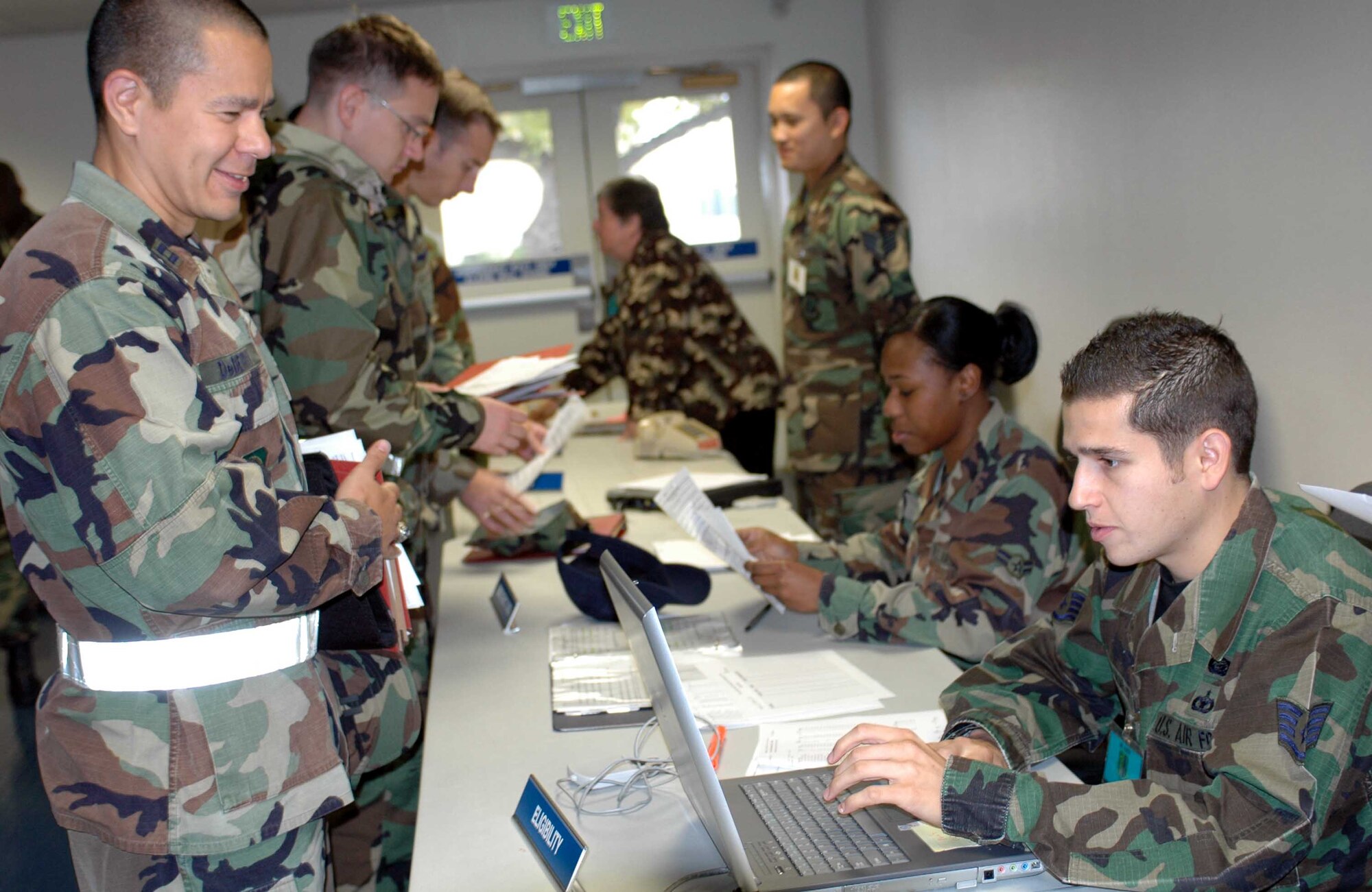 Staff Sgt. Alex Almaraz, (right), 60th Mission Support Squadron, checks Capt. Jefferson DeBerry, 15th Air Mobility Operations Squadron, personnel records as Captain DeBerry processes through the deployment line Oct. 12. Captain DeBerry is deploying in support of the 615th Contingency Response Wing's first-ever Operational Readiness Inspection Oct. 10 to 18 at Gulfport, Miss. (U.S. Air Force photo/Staff Sgt. Candy Knight)