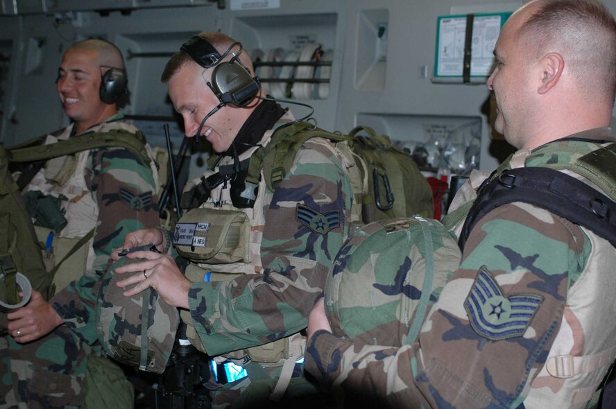 Members of the 615th Contingency Response Wing inspect their equipment while waiting for takeoff Oct. 12. The wing faces their first-ever Operational Readiness Inspection, Oct. 10 to 18 at Gulfport, Miss., since standing up the wing in April 2005. (U.S. Air Force photo/Staff Sgt. Candy Knight)