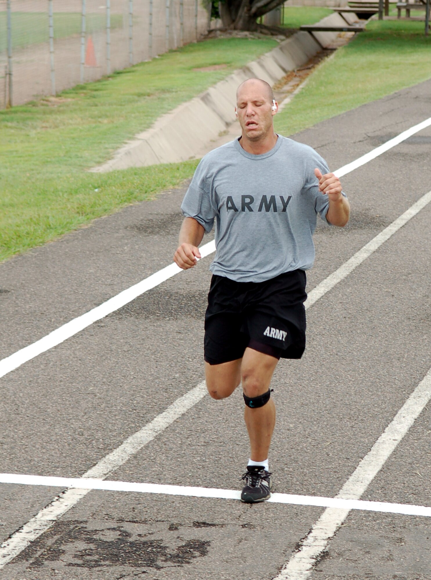 SOTO CANO AIR BASE, Honduras – In the last few moments of the Joint Task Force-Bravo POW/MIA Remembrance Run, Army Sgt. Pete Schaffer reaches his self-designated finish line, having completed 29.5 miles over the entire duration of the event.  A total of approximately 170 participants ran in mostly 15-minute intervals for 24 hours to show support for their fellow servicemembers who have been listed as POW/MIA.  (U.S. Air Force photo by Staff Sgt. Austin M. May)