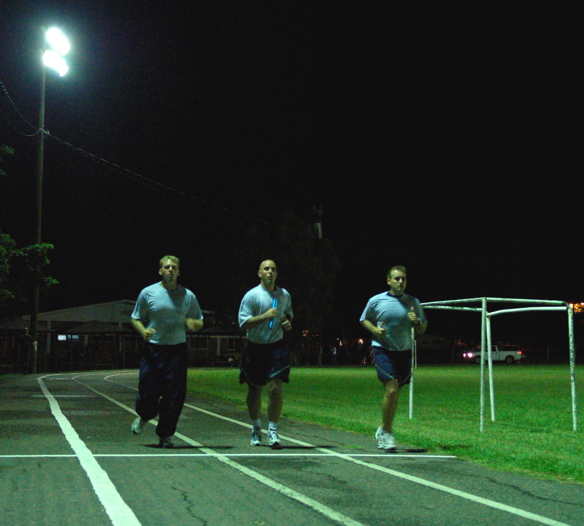 SOTO CANO AIR BASE, Honduras – A few minutes after midnight Oct. 12, Air Force Staff Sgts. Christopher Evans and Jason Caswell, along with Air Force Tech. Sgt. Brandon Williford, keep the 24-hour Prisoner of War/Missing in Action Remembrance Run going through the night.  A total of approximately 170 participants ran in mostly 15-minute intervals for 24 hours to show support for their fellow servicemembers who have been listed as POW/MIA.  (U.S. Air Force photo by Staff Sgt. Austin M. May)