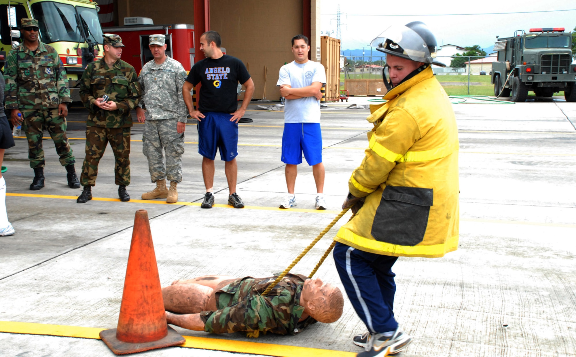 SOTO CANO AIR BASE, Honduras - Army 2nd Lt. Miles Hamlett, Joint Task Force Bravo Medical Element, weaves through cones dragging a mannequin in the Fire Department's Fire Muster Challenge here Oct. 12.  The relay challenge was Soto Cano Fire Department's closing event for Fire Prevention Week.  (U.S. Air Force photo by 1st Lt. Erika Yepsen)